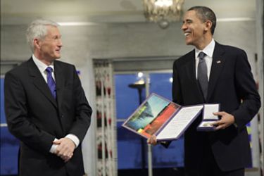 Nobel Peace Prize laureate, US President Barack Obama (R) smiles by Chairman of the Norwegian Nobel Committee, Thorbjoern Jagland after receiving the diploma and medal at the Nobrel Peace prize award ceremony at the City