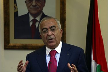 AFP - Palestinian Prime Minister Salam Fayyad stands in front of a portrait of Palestinian leader Mahmud Abbas during a joint press conference with Italian Foreign Minister Franco Frattini