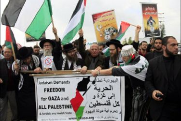 afp : US members of Neturei Karta, a fringe ultra-Orthodox movement within the anti-Zionist bloc, Palestinians and foreign activists take part in a protest in the Gaza Strip side