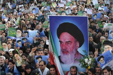 Thousands of pro-government Iranian protesters, holding up pictures of Supreme leader Ayatollah Ali Khamenei (back with green background) and his