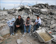 عائلة فلسطينية في رهط على أنقاض منزلهم الذي هدمته إسرائيل (الجزيرة نت-أرشيف)