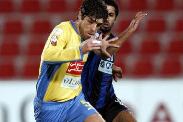 r : Al-Sailiya's Ali Almery fights for the ball with Al-Gharafa's Juninho (L) of Brazil during their semi-final Qatar Stars Cup soccer match in Doha January 1, 2010. REUTERS/Fadi Al-