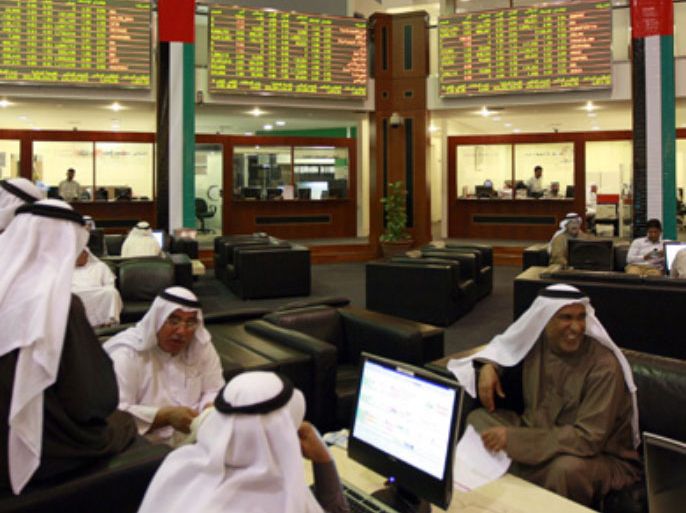 Investors view stock exchange information at the Dubai Financial Market January 3, 2010. Middle East markets should make a steady start to 2010 on Sunday as a positive international backdrop and the grand opening of Burj Dubai -- the world's tallest tower -- bolsters sentiment following a turbulent past 12 months.