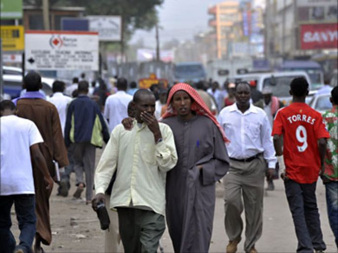 f_Residents of Eastleigh, a neighbourhood of Nairobi known for it's densely Somali origin population, walk on January 18, 2010 in a business street of Eastleigh. Kenyan police