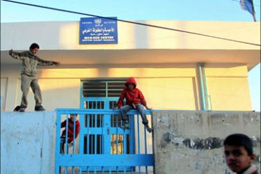 afp ; Jordanian boys play on January 5, 2010 outside the gate of an UNRWA clinic, where Jordanian Al-Qaeda triple agent Humam Khalil Abu Mulal al-Balawi used to work as a doctor,