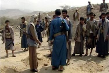 r : Yemeni Shi'ite rebels stand by a road while waiting to remove landmines in the northwestern province of Saada, in this video grab obtained from Yemeni TV February 15, 2010.