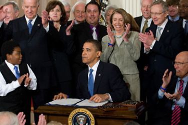 Lawmakers applaud as US President Barack Obama finishes signing the healthcare insurance reform legislation during a ceremony in the East Room of the White House in Washington on March 23, 2010.