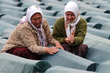 (FILE) This picture taken on 10 July, 2009 shows Bosnian Muslim women weeping by the coffin of her relative among coffins of Srebrenica victims displayed at the memorial centre of Potocari near Srebrenica.