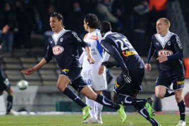 Bordeaux' forward Marouane Chamakh (L) jubilates after he scored a goal during the French L1 football match Bordeaux vs Montpellier, on March 7, 2010 at the Chaban-Delmas stadium in Bordeaux.