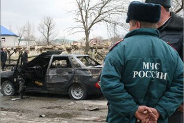 Russian forensic investigators and security personnel examine the site of a bomb attack in Kizlyar on March 31, 2010. Suicide bombers killed 12 people in double strikes targeting police in Russia's turbulent North Caucasus, shaking the country just two days after attacks in Moscow left 39 dead. Prime Minister Vladimir Putin said the latest attack in the North Caucasus region may be linked to the strikes on the Moscow metro by two female suicide bombers while President Dmitry Medvedev