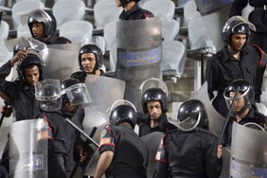 Security officers are seen during clashes with fans of El Masry during their Egyptian Premier League soccer match aginst Al Ahly at Cairo Stadium,
