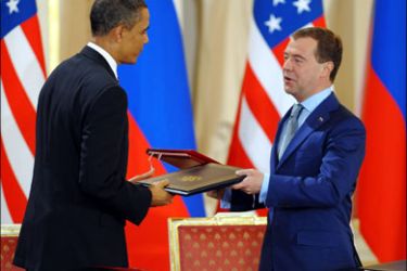 afp : US President Barack Obama (L) and Russian President Dmitry Medvedev exchange the signed new START Treaty documents at the Prague Castle in Prague on April 8, 2010.