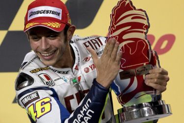 Nine-time Italian world champion Valantino Rossi of Fiat Yamaha team jubialtes after winning the MotoGP final race at the Losail International Circuit in Doha