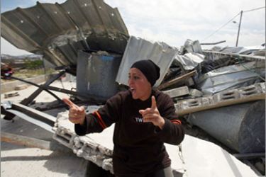 A Palestinian woman reacts in front of the ruins of her house which was demolished by Israeli troops in the West Bank village of Al-Khader near Bethlehem on April 14, 2010.