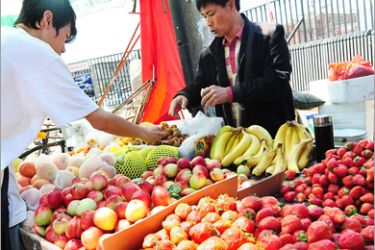 AFP - A man buys fruit from a roadside vendor in Beijing on May 11, 2010. Consumer prices in China accelerated in April increasing pressure on policymakers in the world's third-