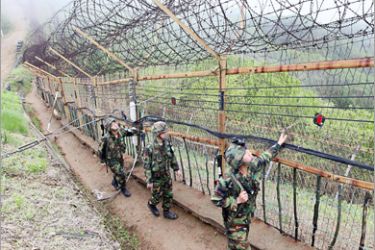 AFP - South Korean soldiers patrol along a wire fence at border with North Korea in Yanggu, 130 km northeast of Seoul, on May 24, 2010. South Korea announced trade and shipping