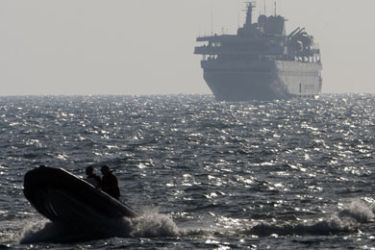 A speed boat escorts Turkish ship Mavi Marmara with Israeli troops on board near the southern port of Ashdod on May 31, 2010, after the Israeli navy raided a flotilla of aid ships bound