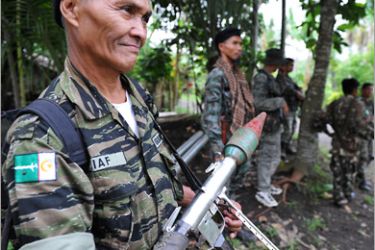 AFP (FILES) This file photo taken on September 19, 2009 shows a member of the southern Philippine rebel group, the Moro Islamic Liberation Front (MILF), holding a rocket propelled
