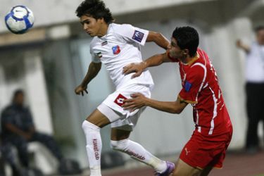 Kuwait SC's Brazilian midfielder Rogerinho (L) is challenged by Syrian Al-Ittihad's Yussef Asil as he goes for a header during their AFC Cup round of 16 football match in Kuwait City on May 12, 2010.