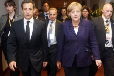 France's President Nicolas Sarkozy (front L) and Germany's Chancellor Angela Merkel (front R) walk together during a Euro Zone leaders summit in Brussels