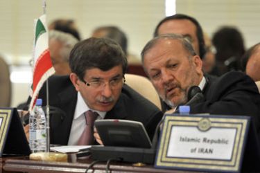 Turkish Foreign Minister Ahmet Davutoglu (L) speaks with Iranian Foreign Minister Manouchehr Mottaki as they attend a meeting of Foreign Ministers of the Organisation of the Islamic conference to discuss Israel's deadly raid on a convoy of ships carrying aid to the blockaded Gaza on June 6, 2010, in the Red Sea port city of Jeddah.