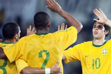 F/Brazil' Kaka (R) celebrates his goal against Tanzania with teammates Daniel Alves (L) and Maicon during a WC2010 friendly football match on June 7, 2010 at the National stadium in Tanzania, ahead of the WC2010 FIFA World Cup held in South Africa. AFP PHOTO/ ANTONIO SCORZA