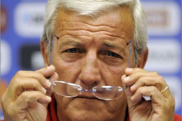 Italy's coach Marcello Lippi adjusts his glasses as he gives a press conference at Cornwall Hill College on June 15, 2010 in Irene, south of Pretoria. Italy drew 1-1 with Paraguay in their Group F first round 2010