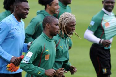 Cameroon's striker Samuel Eto'o (L, centre) and defender Rigobert Song (R, centre) jog with teammates during the first training session of the national football team at Northlands School in Durban, on June 10, 2010 on the eve of the South Africa 2010 World Cup kick off.