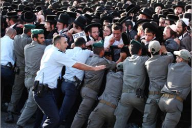 . AFP- Israeli security forces try to control a crowd of around 100,000 ultra-Orthodox Jews outside the central police station in Jerusalem on June 17, 2010, protesting against a school