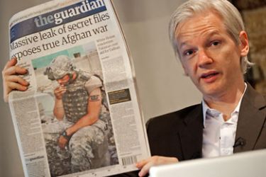 WikiLeaks', Julian Assange, holds up a copy of today's Guardian newspaper during a press conference in London on July 26, 2010.