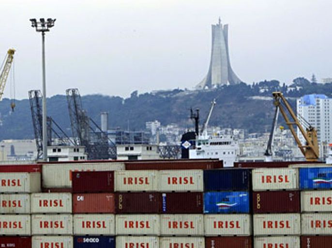 r : Containers are seen at a dock in Algiers August 10, 2010. Since import restrictions were introduced last year as part of a trend towards economic nationalism that has also seen