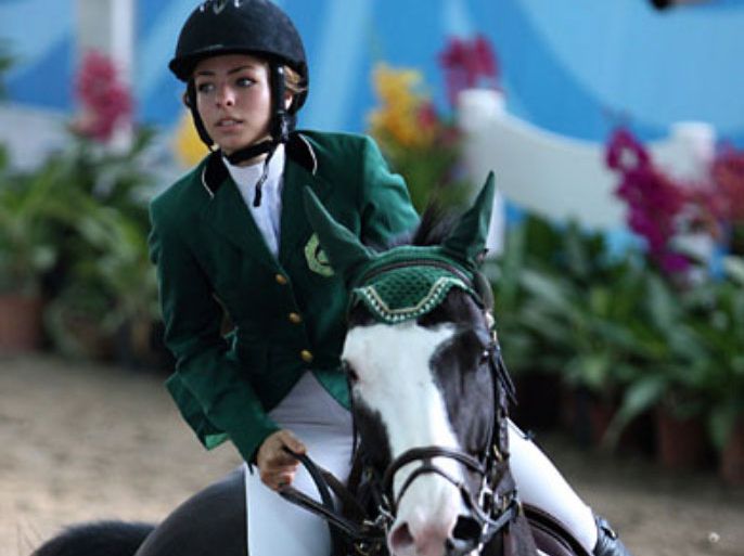 Dalma Rushdi Malhas of Saudi Arabia riding on the horse Flash Top Hat to compete in the jumping individual round B match of the equestrian event at the 2010 Youth Olympic Games in Singapore on August 24, 2010. AFP PHOTO / HO / Duan Zhuoli / SYOGOC