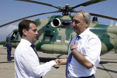 Russian President Dmitry Medvedev (L) shakes hands with Abkhazia's rebel leader Sergei Bagapsh while visiting the Russian military base in Gudauta on August 8, 2010.