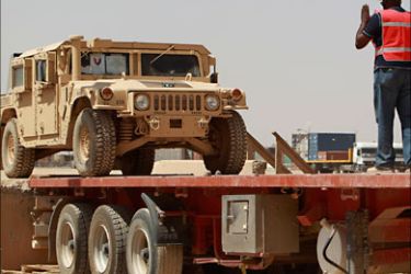 r_A worker gives directions to load up a humvee as the U.S. troops prepare to leave Iraq at Balad Base, 80 km (50 miles) north of Baghdad August 27, 2010