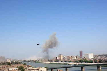A helicopter flies towards a plume of smoke following a large explosion on September 05, 2010, that rocked an Iraqi ministry of defence complex near the headquarters of Rusafa Military Command in eastern Baghdad, that three weeks ago was the site of a suicide bomb attack that killed dozens of would-be army recruits.