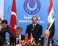 الشهرستاني ووزير الطاقة التركيأثناء توقيع الاتفاق في بغداد (الفرنسية)