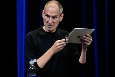r_Apple Chief Executive Steve Jobs uses an iPad to run Apple TV as he speaks on stage at Apple's music-themed September media event in San Francisco, California