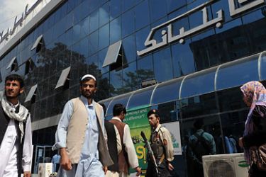 Pedestrians walk past the Kabul Bank in Kabul on September 1, 2010. Afghanistan's central bank governor said that the country's biggest bank, Kabul Bank was in no danger of collapse following allegations of corruption in the US media. AFP PHOTO/SHAH Marai