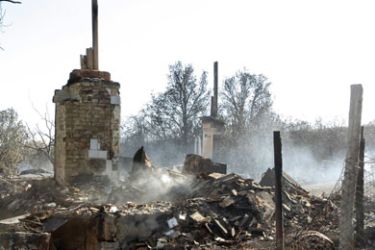 A house burnt-out by forest fires smoulders in the Volgograd region of Russia on September 3, 2010. Eight people have died as forest and brush fires flared up again in Russia's southern farmlands, burning down 532 homes and buildings, officials said today.