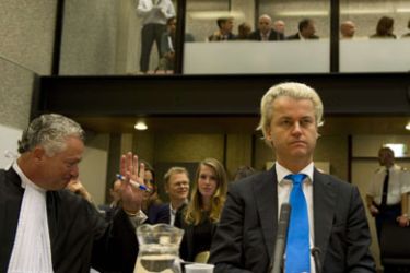 Dutch anti-Islam deputy Geert Wilders (R), set to become a shadow partner in the next Dutch government, sits in court on October 4, 2010 next to his lawyer Bram Moszkovicz (L) before the start of his trial on charges of inciting racial hatred against Muslims.