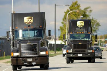 PHILADELPHIA - OCTOBER 29: UPS trucks drive by the scene where a cargo plane was searched for explosives after a suspicious package was found onboard October 29, 2010 at Philadelphia International Airport in Philadelphia, Pennsylvania.