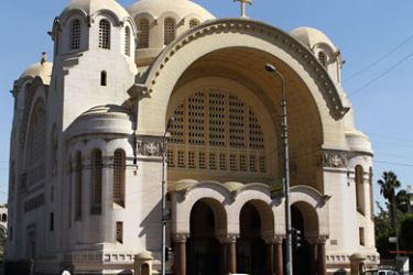 An Egyptian policeman (bottom L) patrols in front of a Coptic church in Cairo on November 2, 2010 as Egypt refused to react to demands over two Coptic women rumoured to have converted to Islam made by an Al-Qaeda group in Iraq that claimed a deadly hostage-taking in a Baghdad church. AFP PHOTO/KHALED DESOUKI
