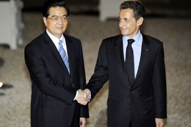 France's President Nicolas Sarkozy shakes hands with Chinese counterpart, Hu Jintao, at the presidential Elysee Palace prior to their dinner, on November 4, 2010 in Paris. Chinese President Hu Jintao Hu is on a three-day state visit during which France hopes to clinch