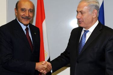 ISRAEL OUT A handout picture from the Israeli Government Press Office (GPO) shows Israeli Prime Minister Benjamin Netanyahu (R) shaking hands with Egyptian intelligence chief Omar Suleiman following a meeting in Tel Aviv on November 4, 2010 during the