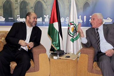 In this handout picture released by the press office of Hamas in Syria, the Palestinian Islamist movement's leader Mussa Abu Marzuq (L) meets with Palestinian lawmaker and Fatah strongman Azzam al-Ahmed in Damascus on November 9