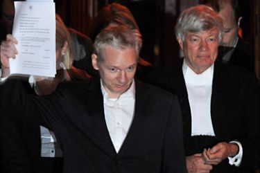 f_WikiLeaks founder Julian Assange reacts as he leaves the High Court in central London on December 16, 2010. The founder of the WikiLeaks website Julian Assange was