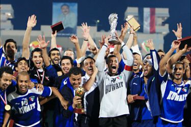 r_Kuwait's players and team members celebrate winning the Gulf Cup soccer tournament in Aden December 5, 2010. REUTERS/Mohammed Dabbous