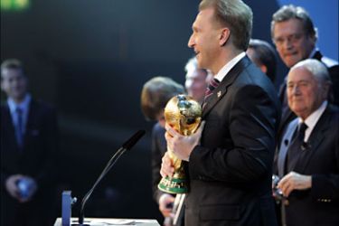 f_Russia's Deputy Prime Minister Igor Shuvalov poses with the World Cup trophy after the official announcement that Russia will host the 2018 World Cup on December 2, 2010