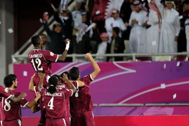 Qatar's Fabio Cesar (R) celebrates with his team mates after scoring a goal from a free kick against Kuwait during their AFC Asian Cup Qatar 2011 group A