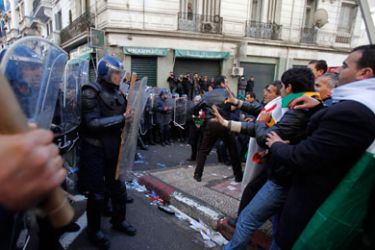 Protesters argue with riot police as they try to disperse them during a demonstration in downtown Algiers, January 22, 2011. A small group of Algerian opposition supporters trying to hold a banned protest clashed with police in the capital and several people were injured, protest organisers and official media said on Saturday.